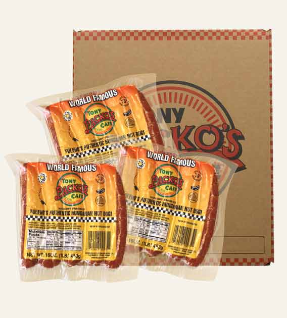 Tony Packo Hungarian Hot Dog packs in front of a yellow box of hot dogs and red box of hot dog chili sauce